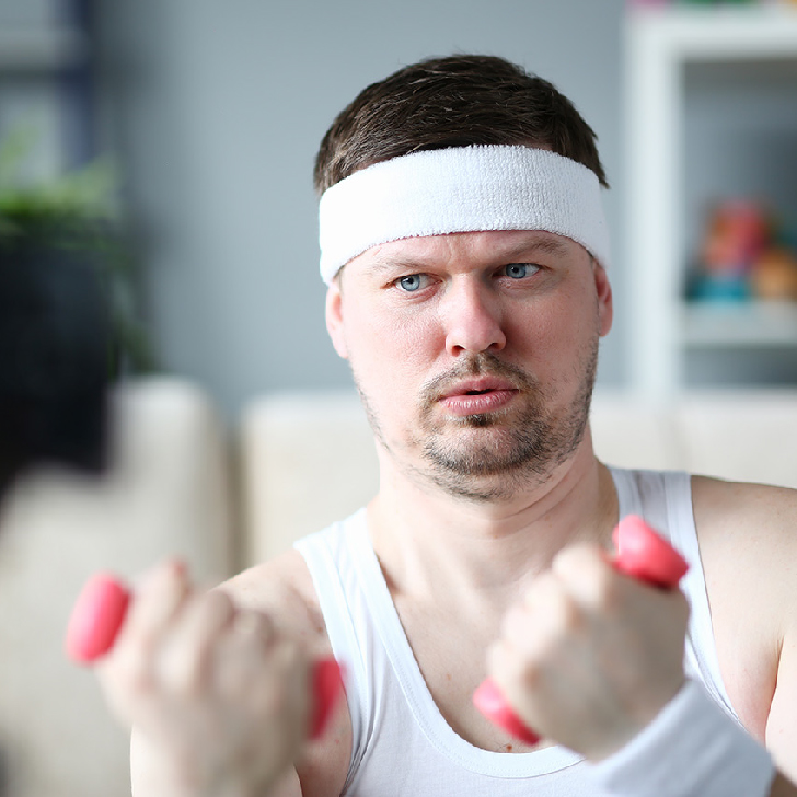 Harry Smith wearing a headband and lifting his comically small pink weights.